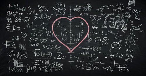 A blackboard with comical mathematic equations of love and a large pink heart drawn on it