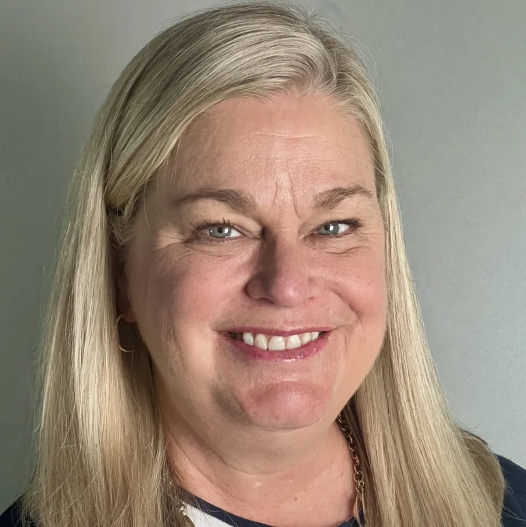 Julie Tressler, LCSW, a therapist at Athena Care, a white woman smiling with blonde hair. 