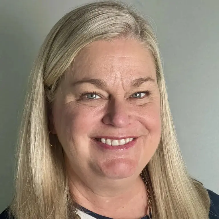 Julie Tressler, LCSW, a therapist at Athena Care, a white woman smiling with blonde hair.
