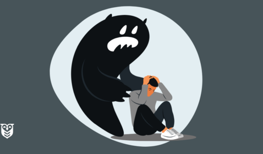 A young man is overwhelmed by anxiety and sits on the floor. A large monster, representing anxiety, is behind him.