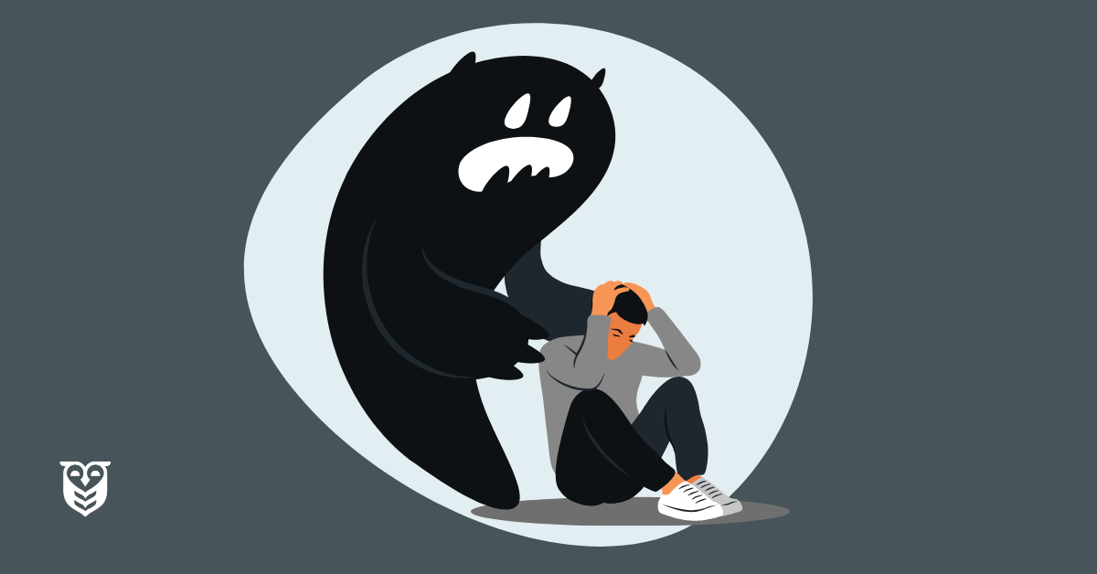 A young man is overwhelmed by anxiety and sits on the floor. A large monster, representing anxiety, is behind him.